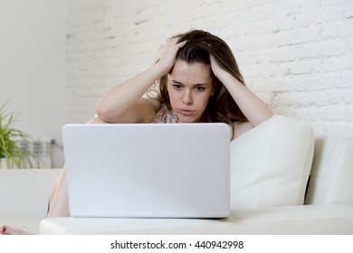 Young Attractive Disappointed Woman Sitting At Home Living Room Couch Using The Internet For Studying On Laptop Computer Looking Unhappy Bored And In Stress  