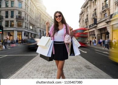 Young, Attractive Fashionista City Woman With Many Bags In Her Hand Goes Shopping At The Regent Street In London, United Kingdom