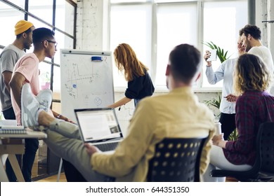 Young attractive female employee making presentation of her project for advertising campaign writing on whiteboard, young hipster girl noting on flipchart suggestion during brainstorming session
 - Powered by Shutterstock