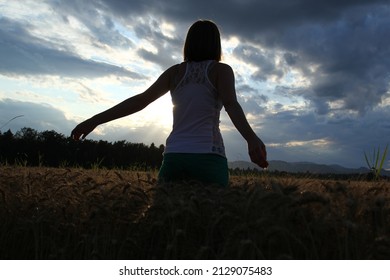 Young attractive female, girl, in the ripe barley field.