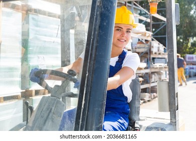 Young attractive female worker working on forklift truck at construction store warehouse - Powered by Shutterstock