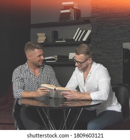 Young Attractive Gay Couple Reading Books