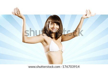 Young attractive girl holding white blank banner above head