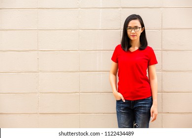 Young Attractive Girl Wearing A Red T Shirt Standing On Brick Wall Background 