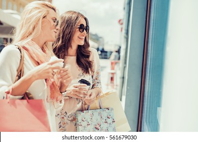 Young Attractive Girls With Shopping Bags In The City.