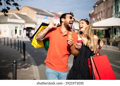Young attractive happy couple with shopping bags outdoors
