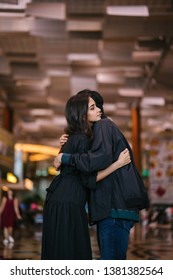 A Young And Attractive Indian Asian Woman Is Hugging Her Boyfriend In A Futuristic Airport During The Day. She Looks Sad At The Prospect Of Missing Him As He Goes Out Of Country. 