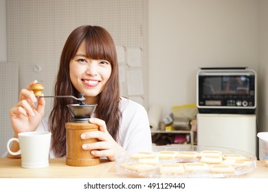 Young Attractive Japanese Woman Brewing Coffee At Home