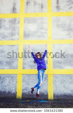 Similar – Image, Stock Photo Happy woman jumping in front of stone wall background