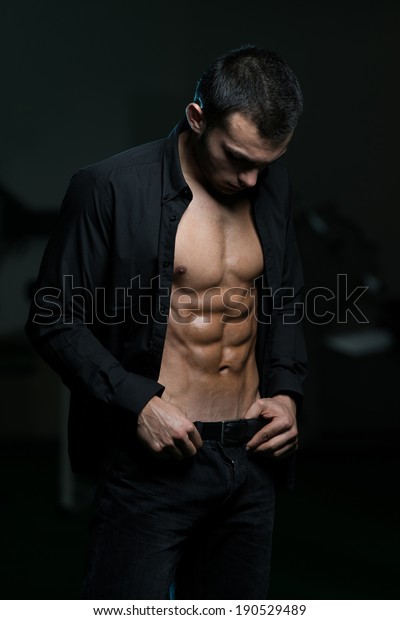 Young\
Attractive Male Model Standing In Unbuttoned\
Shirt