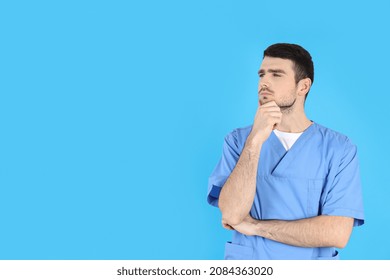 Young Attractive Male Nurse On Blue Background