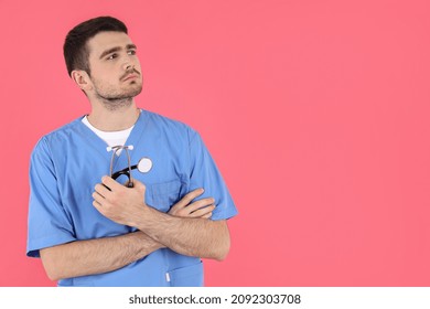 Young Attractive Male Nurse On Pink Background