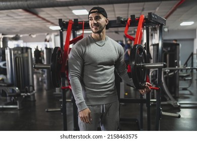 A Young Attractive Male In A Sweat Suit Posing In A Gym