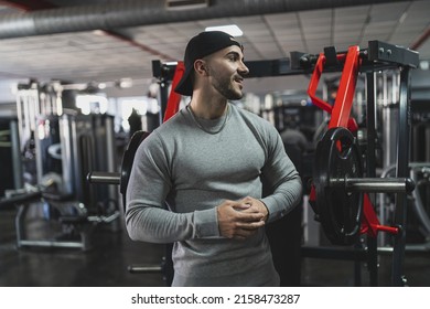 A Young Attractive Male In A Sweat Suit Posing In A Gym