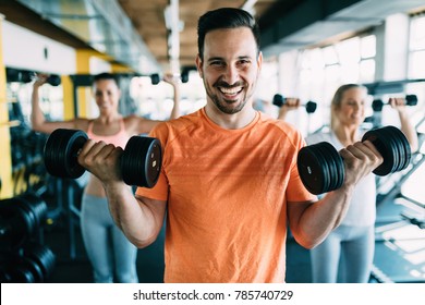 Young attractive man doing exercises in gym - Powered by Shutterstock