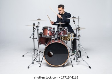 Young Attractive Man Drummer Playing Drums And Cymbals Studio Shot