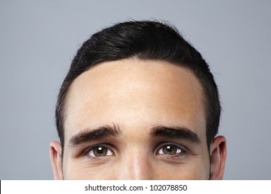 Young attractive man face looking camera