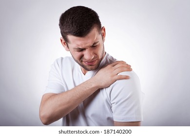 Young attractive man having shoulder pain