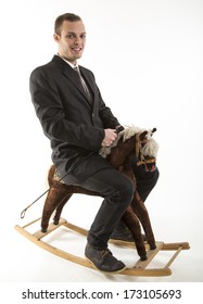 Young Attractive Man On Rocking Horse