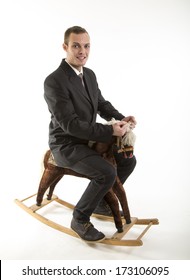 Young Attractive Man On Rocking Horse