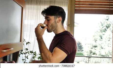 Young Attractive Man Preparing A Cup Of Espresso Coffee With Machine At Home Then Drinking It