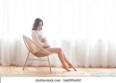 Young attractive pregnant woman indoors. Maternity concept. - Shutterstock ID 1660996450