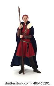 Young And Attractive Red Haired  Female Warrior,  Wearing A Red Medieval Tunic And Leather Armour.  Isolated On A White 
