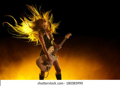 Young attractive rock girl playing the electric guitar - Powered by Shutterstock