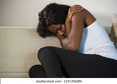 Young Attractive And Sad Black African American Woman Sitting Depressed At Home Sofa Couch Feeling Anxious And Frustrated Suffering Depression Problem And Anxiety Crisis Crying Desperate