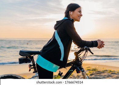 Young Attractive Slim Woman Riding Bicycle, Sport In Morning Sunrise Summer Beach In Sports Fitness Wear, Active Healthy Lifestyle, Smiling Happy Having Fun