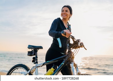 Young Attractive Slim Woman Riding Bicycle, Sport In Morning Sunrise Summer Beach In Sports Fitness Wear, Active Healthy Lifestyle, Smiling Happy Having Fun