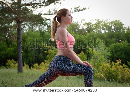 Young attractive slim woman stretching in the park. Healthy lifestyle concept
