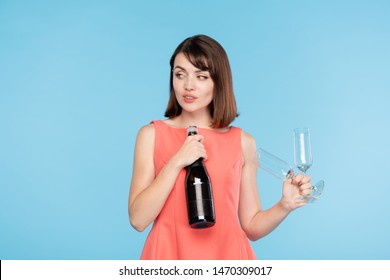 Young Attractive Sly Woman With Two Glutes And Bottle Of Champagne