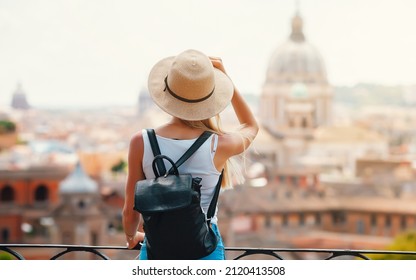Young attractive smiling girl tourist exploring new city at summer - Shutterstock ID 2120413508