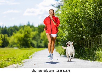 Young Attractive Sport Girl Running With Dog In Park