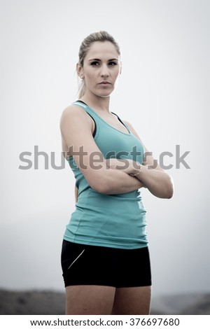 Similar – Close up front portrait of one young athletic woman in sportswear in gym over dark background, standing in boxing stance with hands and fists, looking at camera