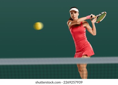 Young attractive sporty woman playing tennis and beating ball with racket - Powered by Shutterstock