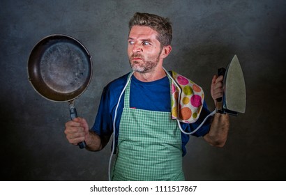 young attractive stressed and overwhelmed lazy man holding kitchen pan and iron in stress and frustrated face expression isolated background in domestic work and messy house husband concept - Powered by Shutterstock