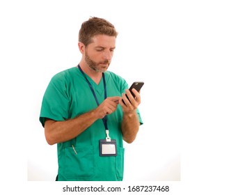 Young Attractive And Successful Medicine Doctor Or Nurse Man Posing Confident  In Green Medical Uniform Using Mobile Phone Standing Isolated On White Background