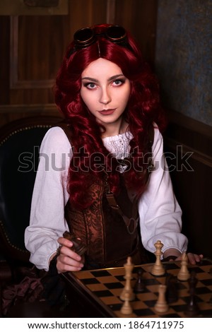 Young attractive vintage steampunk girl indoors playing chess portrait