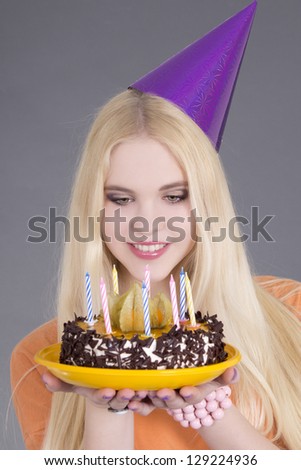 young attractive woman with birthday cake over grey