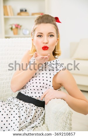 Young attractive woman blowing a kiss.