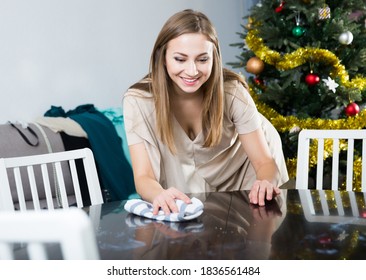 Young Attractive Woman Cleaning In House Before Christmas Celebration, Wiping Table..