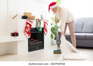 Young Attractive Woman Cleaning In House Before Christmas Celebration