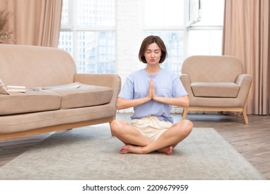 Young Attractive Woman Doing Yoga On The Floor At Home. Stressful Day And Calm Down Concept	