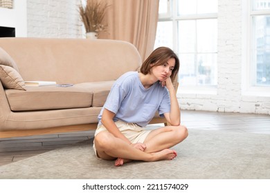 Young Attractive Woman Doing Yoga On The Floor At Home. Stressful Day And Calm Down Concept	