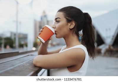 Young Attractive Woman Drinking Coffee From Red Cup.