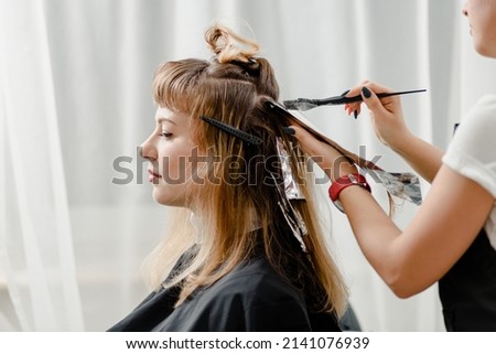 Similar – Image, Stock Photo Hair style, hairdresser, beauty and customer service concept. Cropped shot of barber man hands hold professional stylish gold hairbrush and scissors by the workplace, leather black chair in barbershop