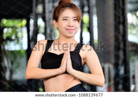 Young attractive woman exercising,asian woman practicing  yoga indoors