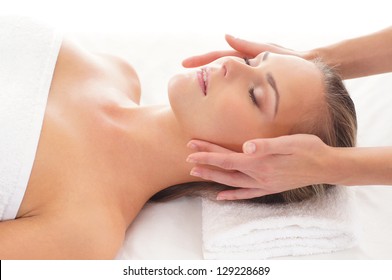 Young Attractive Woman Getting Spa Treatment Over White Background